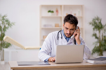 Young male doctor in telemedicine concept