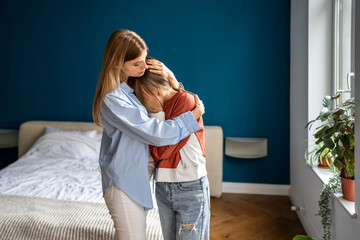 Loving caring mother hugging teen daughter. Parent mom showing understanding and support to upset...