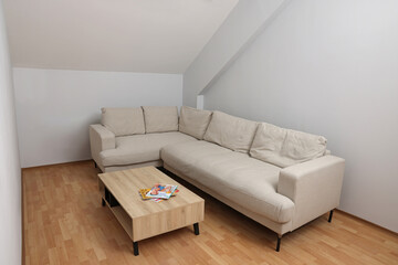 Attic room interior with slanted ceiling and furniture