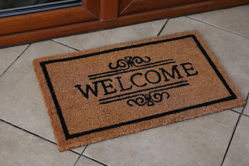 Door mat with word Welcome on floor