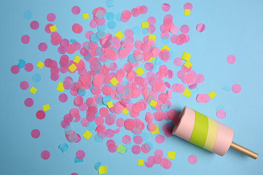 Party Popper With Bright Confetti On Light Blue Background, Flat Lay