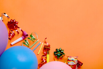 Flat lay composition with accessories for birthday party on orange background. Space for text