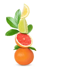 Foto op Plexiglas Stack of different fresh citrus fruits with green leaves on white background © New Africa