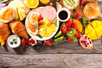 healthy breakfast with egg,  toast,  croissant, fresh fruit and coffee cup