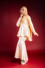 Portrait of a beautiful Asian Muslim female model wearing hijabwear with at a studio photoshoot. Modern hijab fashion and beauty concept