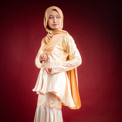 Portrait of a beautiful Asian Muslim female model wearing hijabwear with at a studio photoshoot. Modern hijab fashion and beauty concept