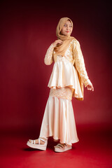 Fototapeta premium Portrait of a beautiful Asian Muslim female model wearing hijabwear with at a studio photoshoot. Modern hijab fashion and beauty concept