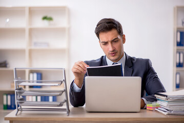 Young male employee working in the office
