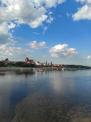 Fototapeta na wymiar View of Old City of Torun. Vistula (Wisla) river against the backdrop of the historical buildings of the medieval city of Torun. Poland.