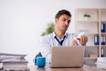 Young male employee working in the office