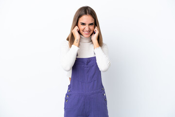 Fototapeta premium Young caucasian woman isolated on white background frustrated and covering ears