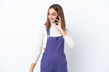 Fototapeta premium Young caucasian woman isolated on white background keeping a conversation with the mobile phone with someone