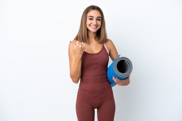 Young sport caucasian woman going to yoga classes isolated on white background pointing to the side to present a product