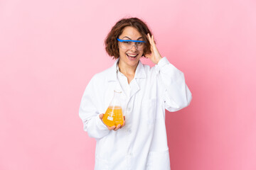 Young English scientific woman isolated on pink background with surprise expression