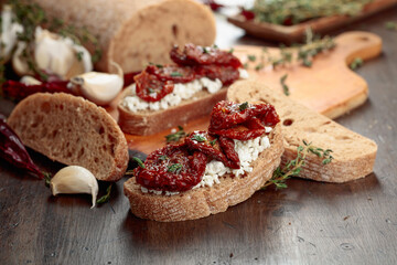 Bruschetta with ricotta, sun-dried tomatoes, and thyme.