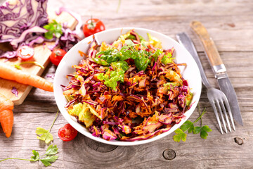 Salad coleslaw - red cabbage with carrots on white dish