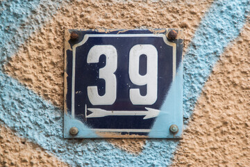 Weathered grunge square metal enameled plate of number of street address with number 39