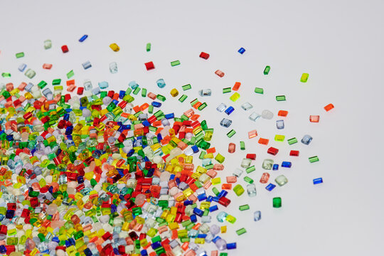 Dumped transparent multicolored plastic resin granulate for background