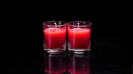 Red candle glass isolated black background