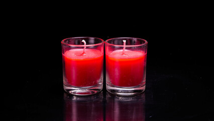 Red candle glass isolated black background