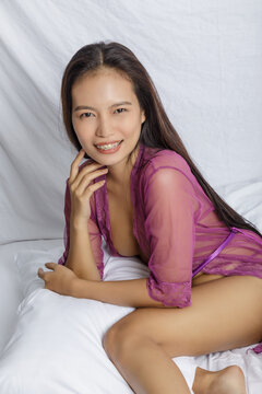 Philippine woman posing in sexy Purple Silk Lngerie white background