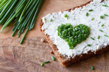 Sandwich with cream cheese and heart-shaped chives, concept