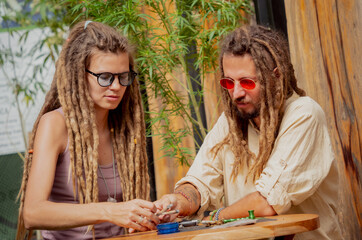Fototapeta premium Hippie style couple smoking cigarettes with medical marijuana