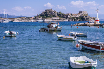 Fototapeta na wymiar Old Fortress and boats on Garitsa Bay, Ionian Sea coast in Corfu town on Corfu Island, Greece