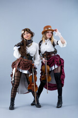 Country girls duet with violins on the grey background.