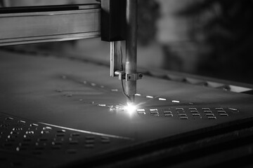 laser cutting machine working with sheet metal with sparks metalworking industrial manufacturing factory, close up of sewing machine - Powered by Adobe