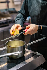 Chef hands cooking sauce in the restaurant kitchen