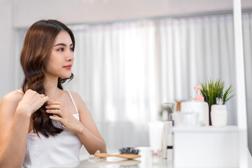 Portrait of smiling cheerful beauty pretty asian woman clean fresh healthy white skin posing smile with black long shiny straight smooth health hair looking on mirror.Haircare cosmetic