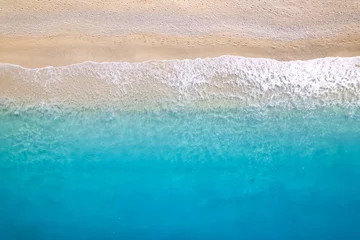 Poster Aerial top down drone shot above an empty beach. © Mazur Travel