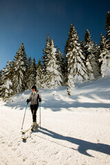 Young woman enjoing winter day of skiing fun in the snow