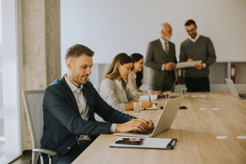 Young business man using laptop computer in the office