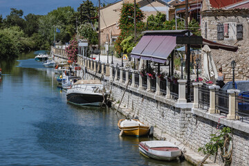 Fototapeta na wymiar View on the water canal in Lefkimmi, small town on Corfu - Kerkyra Island, Greece