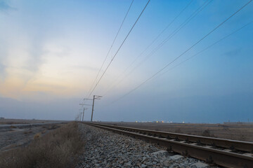 Railroad during colorful winter sunset