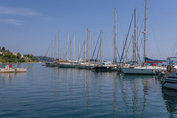 Fototapeta na wymiar Yachts in marina of Benitses town on the Ionian Sea shore on Corfu Island, Greece