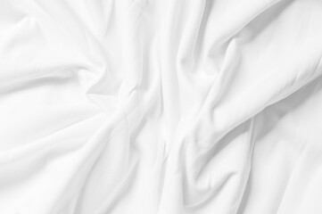 Fototapeta na wymiar Closeup of rippled white silk fabric,white fabric draped in soft waves