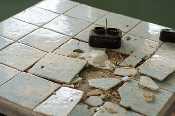 Old, dilapidated tables and coffee tables in an abandoned building. Urbex.
