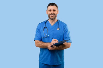 Middle aged male doctor in uniform working with patient anamnesis, standing over blue background and smiling at camera - obrazy, fototapety, plakaty