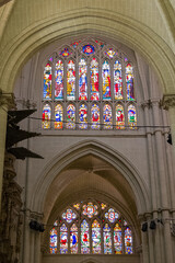 Fototapeta na wymiar Rose windows with mosaic colored glass inside the cathedral of Toledo, Spain