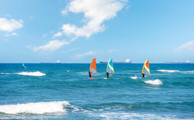 Enjoying extreme windsurfing and ocean waves on a hot sunny day. water sports concept