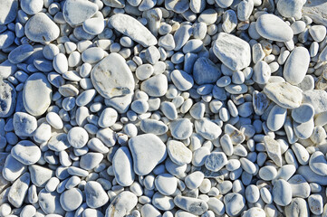 Marble pebbles of different sizes on the beach