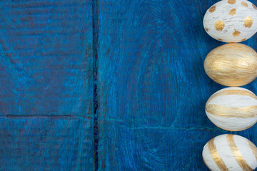 Happy Easter. Painted eggs on wooden table. Top view. Copy space for text.