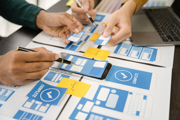 Creative digital development agency. developer team brainstorming on their project with laptop, smartphone and digital tablet.