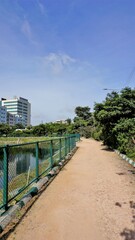 Walking lane of iblur lake with green cover and clear cloudy skyn and cityscape infrastructure.