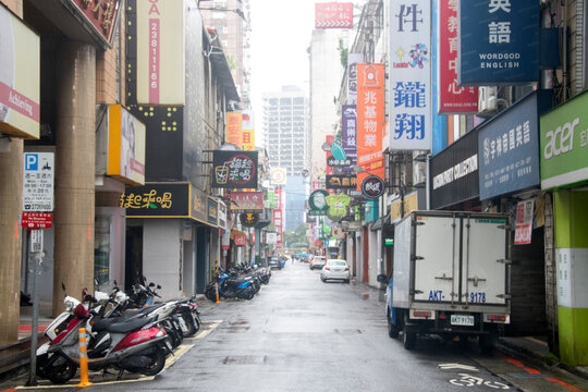 Scenery of street traffic in Taipei with difference dvertisement billboards of shops and stores along the road.