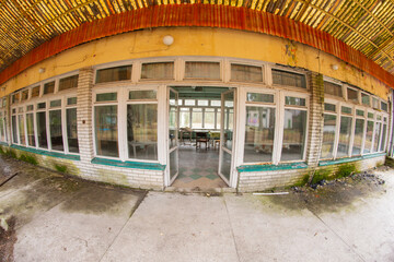Dilapidated and abandoned building, roofing and terrace in a fisheye lens on an autumn day. Urbex,