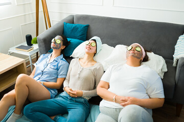 Relaxed young women wearing face masks at a slumber party
